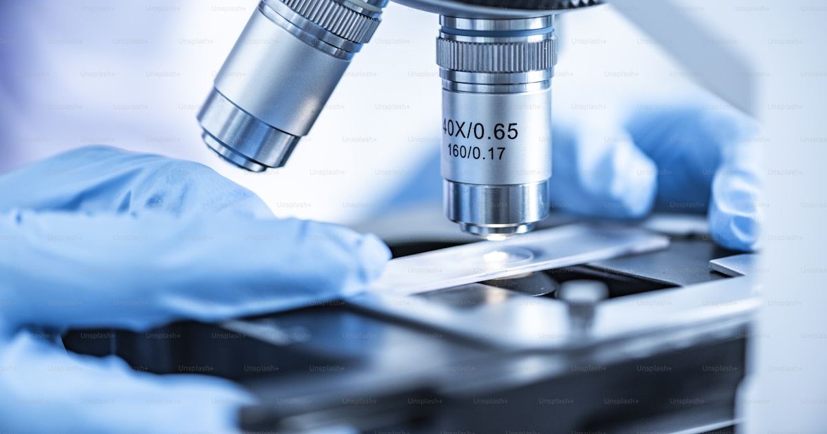 Embryologist working with a microscope in an IVF laboratory