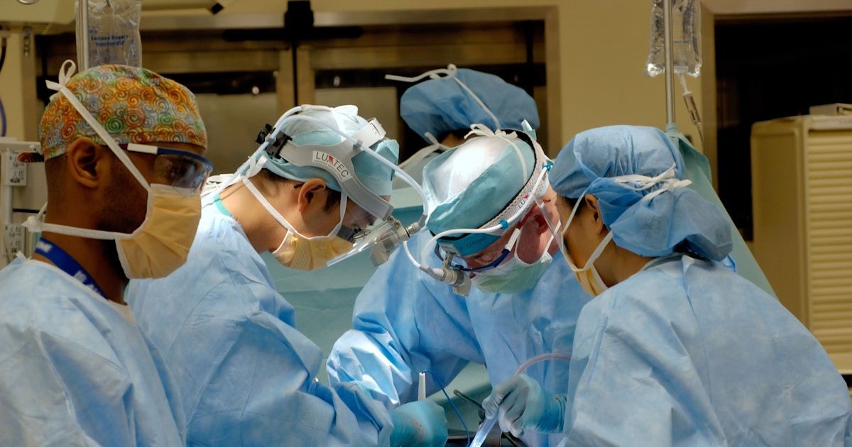 Surgical team performing keyhole laparoscopic gallbladder surgery in an operating theatre