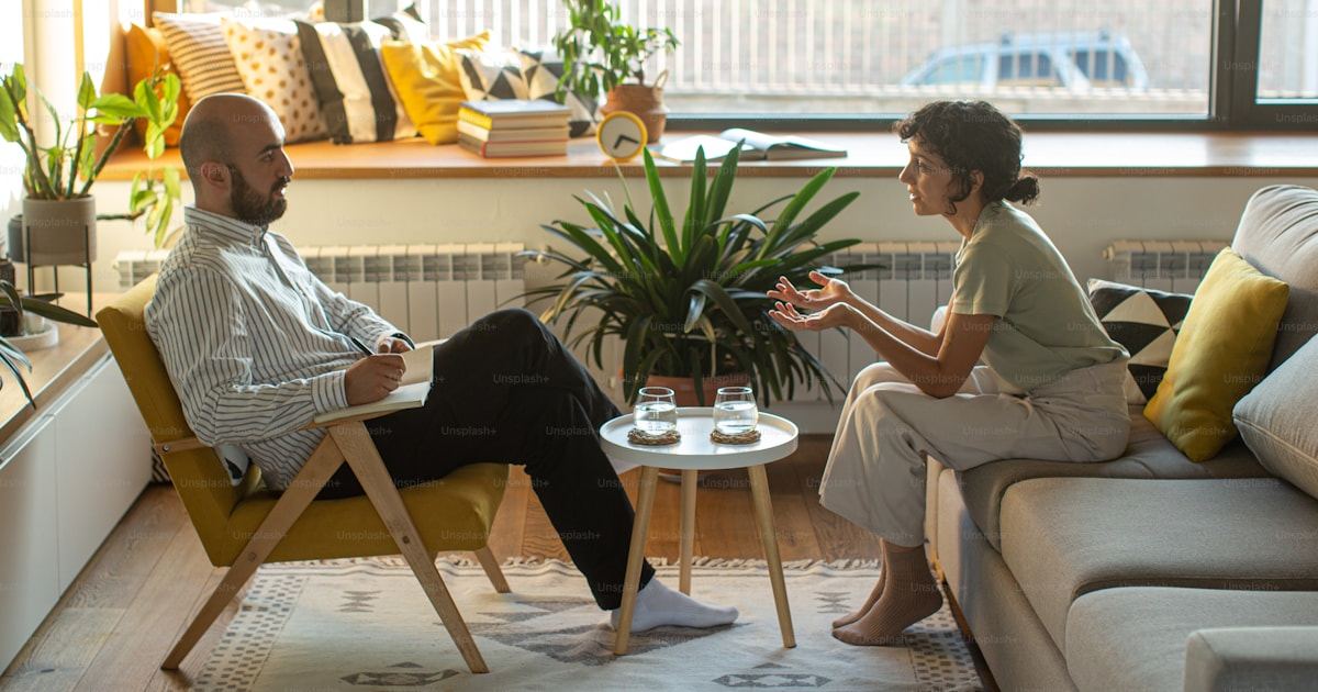 Two people in conversation during a supportive mental health counselling session